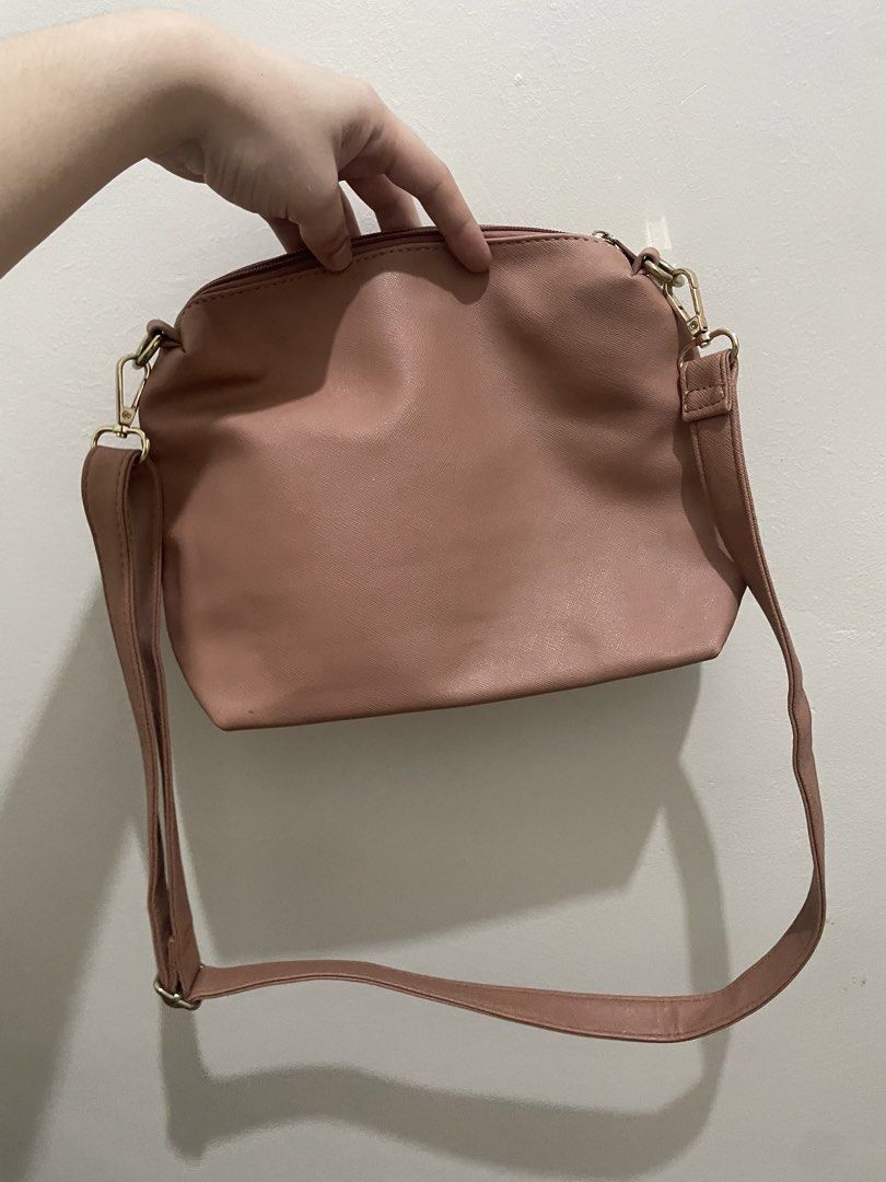 Secosana Pink Crossbody Bag (Category: Cross-body Bags) located in Guiguinto. Submitted by beatan13 (Listing ID 1466445356, Image 2). Description: - Brand: Secosana - Material: Pink faux leather - Hardware: Gold-toned with secure zippers - Strap: Adjustable and removable with lobster clasps - Design: Clean front panel with debossed brand logo - Style: Minimalist and versatile for everyday outfits.