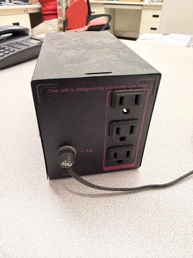 Secure Voltage Regulator UPS Computer Use Only (Category: Electrical, Adaptors & Sockets) located in Manila. Submitted by officialrodz (Listing ID 1466386227, Image 2). Description: - Secure power unit designed specifically for computer setups - Stylish black metal casing with striking red graphic stripes, power switch, and indicator light - Equipped with 3 grounded electrical outlets and a 5A fuse cap on the back - Condition note: Stored in a du