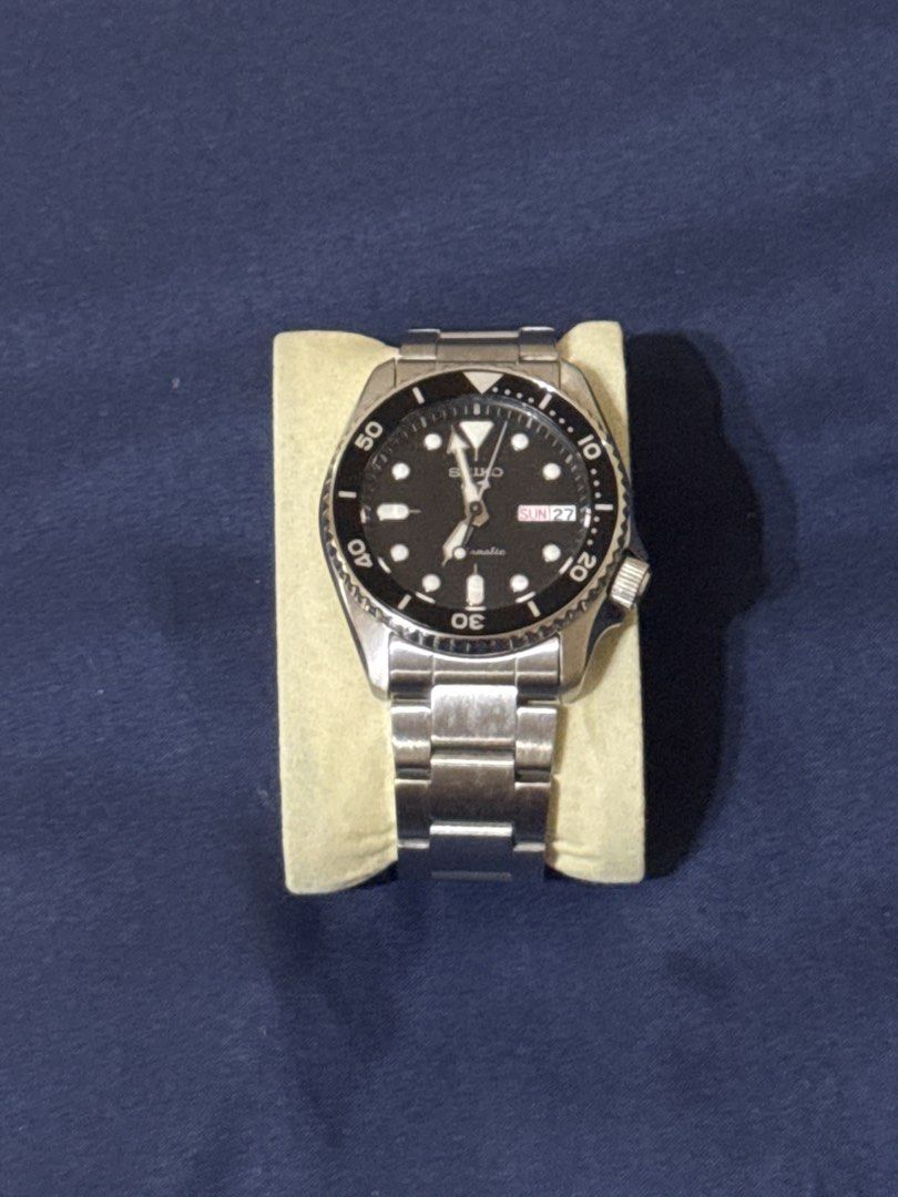 Seiko 5 38mm - Black (Category: Men's Watches) located in Paranaque City. Submitted by boogeycc (Listing ID 1466500353, Image 1). Description: - Brand/Model: Seiko Automatic Watch - Dial: Black dial with round hour markers and day-date display at 3 o'clock - Bezel: Rotating black bezel with white numbers and markings - Case & Bracelet: Durable stainless steel case and link bracelet - Crown: Uniquely positioned at the 4 o'clock side - Performance: