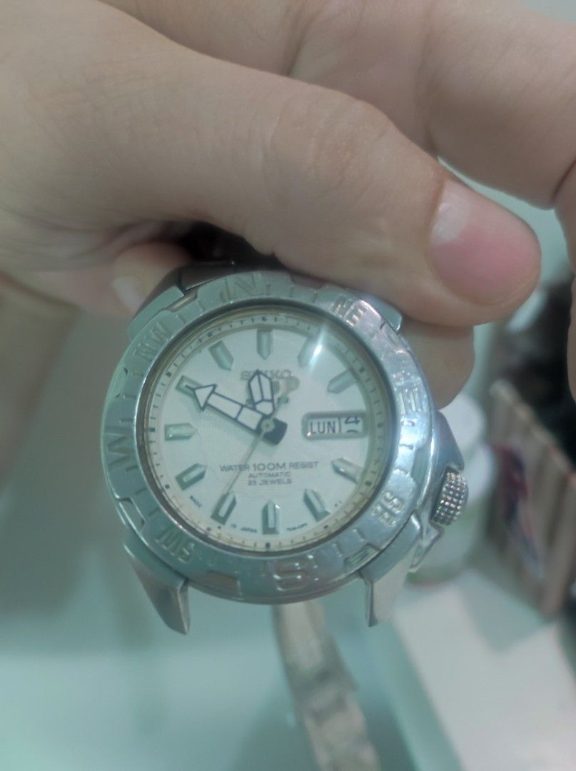 Seiko 5 Sports Automatic Compass Bezel Watch (Category: Men's Watches) located in Pasay City. Submitted by wizemindz138970 (Listing ID 1465647828, Image 2). Description: - Brand: Seiko 5 Sports Automatic Watch - Dial: White textured dial with day-date window at 3 o'clock - Movement: 23 jewels automatic movement with exhibition case back - Build: Stainless steel case and matching bracelet - Features: Rotating compass bezel and bright luminous hand