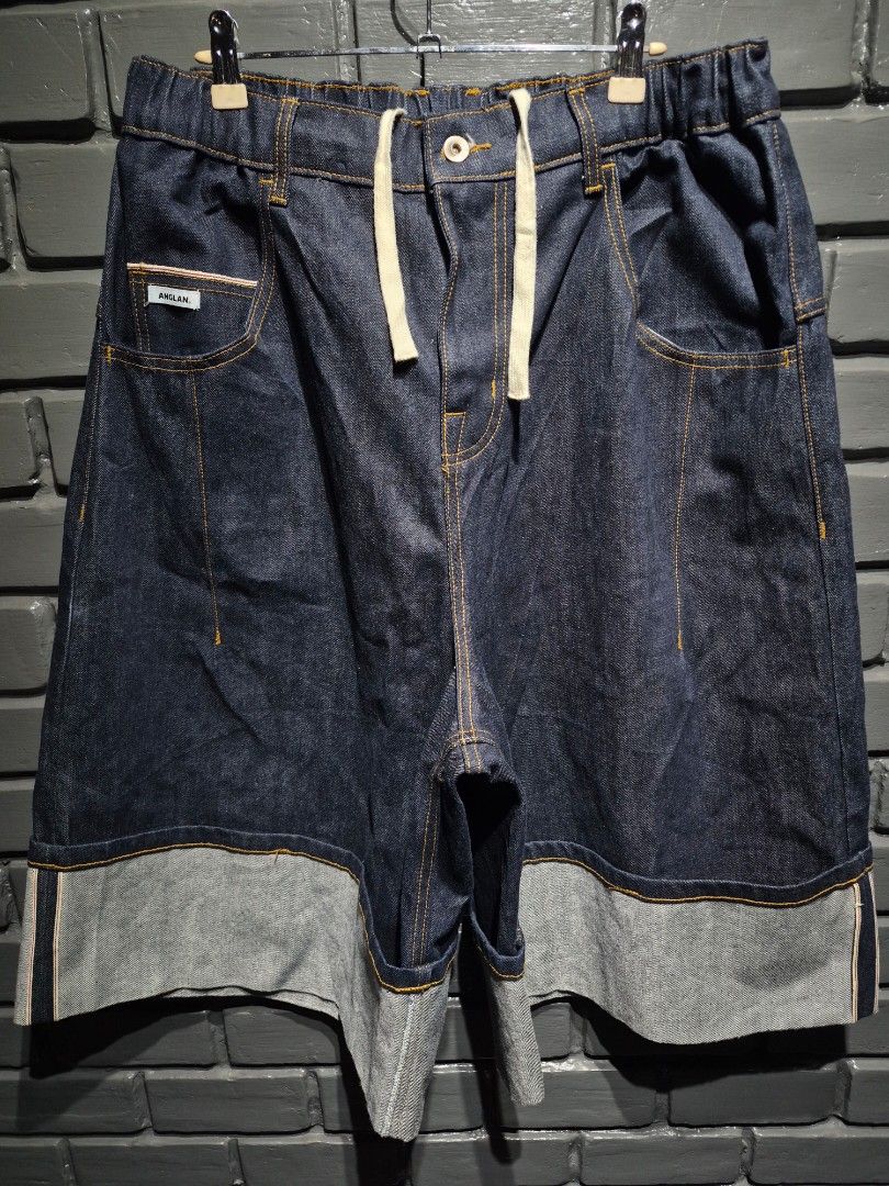 SELVEDGE ANGLAN TURN-UP JORTS DENIM (Category: Jeans) located in Davao. Submitted by rodrigoani57168 (Listing ID 1466421829, Image 3). Description: - Brand: Anglan - Style: Dark wash wide-leg denim shorts with thick rolled cuffs - Style: Wide-fit Bermuda denim shorts (jorts) featuring a distinctive wide turned-up/rolled cuff at the hem, contrast stitching, an elastic drawstring waist with a button fly, and the ANGLAN logo patch on the front pocke