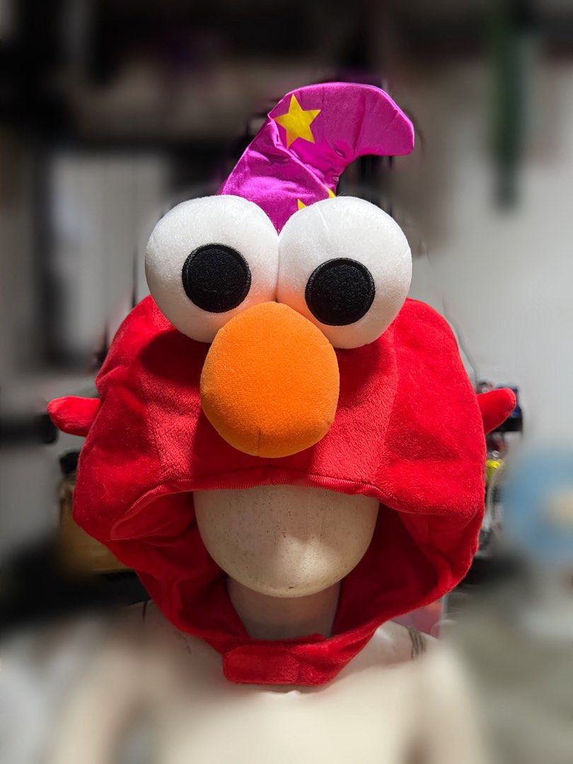Sesame Street Elmo Wizard Hat (Category: Caps & Hats) located in Rizal. Submitted by kate_declutterr (Listing ID 1466477515, Image 1). Description: - Fun and cozy red Elmo headdress from Sesame Street - Features iconic big white googly eyes and a bright orange nose - Made with ultra-soft fabric for ultimate comfort - Convenient velcro closure around the neck - Perfect for cosplay, costume parties, or staying warm on chilly days #Headdress #Elmo #