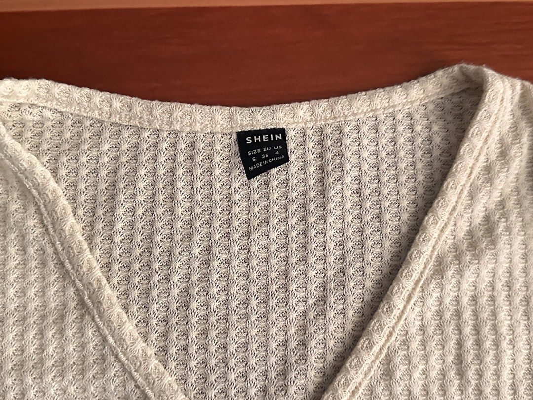 SHEIN Beige V-Neck Crop Top Size S (Category: Sleeveless) located in Minalabac. Submitted by summerrish (Listing ID 1466365422, Image 2). Description: - Brand: Shein - Style: V-neck wrap crop top with short sleeves and lettuce hem - Color: Light Beige - Size: Small (EU 36, US 4) - Material: Textured waffle knit, super lightweight and stretchy - Condition: Great casual piece for warmer weather.