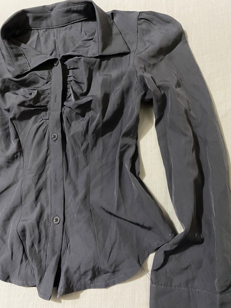SHEIN Grey Ruched Button-Down Long Sleeve Blouse Size XS (Category: Longsleeves) located in Quezon City. Submitted by getitrightaway.ph (Listing ID 1466443460, Image 3). Description: Grey long sleeve blouse from SHEIN. Features ruched detailing down the front button placket, pointed collar, and structured shoulders. Made from 95% polyester and 5% elastane. Size XS with a slim, fitted silhouette. Never used, still in great shape..