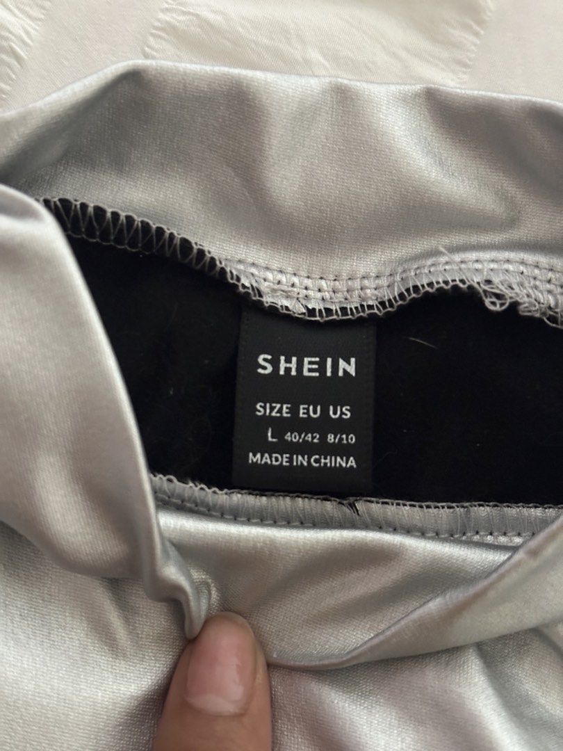 Shein Metallic Silver Mock Neck Crop Top Size L (Category: Sleeveless) located in Mandaluyong City. Submitted by youarecutejeans (Listing ID 1466441892, Image 2). Description: - Brand: Shein - Style: Mock neck, sleeveless crop top with bold futuristic look - Color: Shiny metallic silver with black interior lining - Size: L (EU 40/42, US 8/10) - Occasion: Perfect for parties, music festivals, and clubbing.
