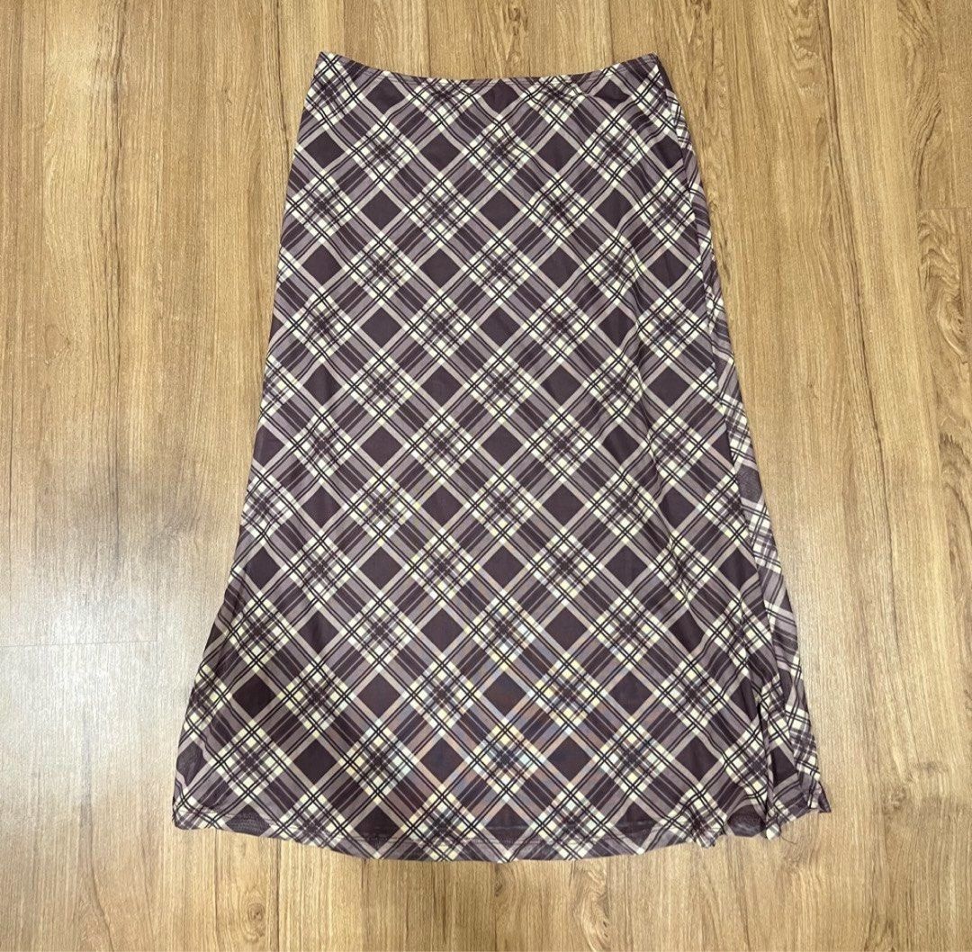 Shein SALE! (Category: Skirts) located in Muntinlupa City. Submitted by shopblank (Listing ID 1466438235, Image 1). Description: - Style: Brown midi skirt with diagonal plaid pattern - Colors: Dark background with cream and grey intersecting lines - Material: Lightweight fabric with a nice drape - Fit: Comfortable elastic waistband - Length: Mid-calf - Condition: Clean, great for casual outfits or layering.