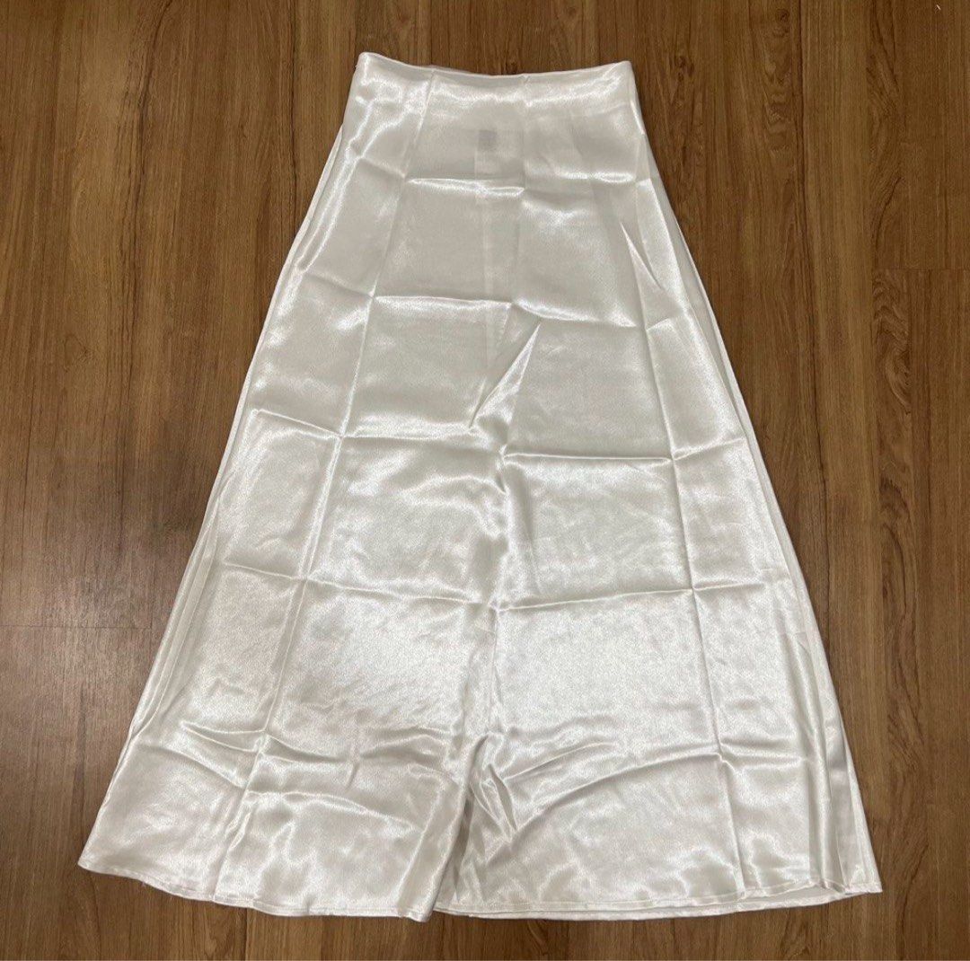 Shein SALE! (Category: Skirts) located in Muntinlupa City. Submitted by shopblank (Listing ID 1466438586, Image 1). Description: - Color: White - Material: Silky satin with a subtle sheen, lightweight drape - Cut: High-waisted with a clean finish waistline - Silhouette: Simple A-line midi - Styling: Easily pairs with basic tops or blouses for casual outings or formal events.