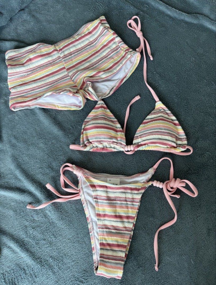 SHEIN Striped Bikini Set (Category: Bikinis & Swimsuits) located in Quezon City. Submitted by japfoodl0ver (Listing ID 1466439880, Image 1). Description: - Brand: SHEIN - Size: XS (tag attached) - Set includes: Triangle top, side-tie bottoms, and matching shorts - Details: Multi-colored stripes, pink straps, and cute bead accents on strings - Condition: Used once - Bought from another carouseller, pics are from her - Price is firm.