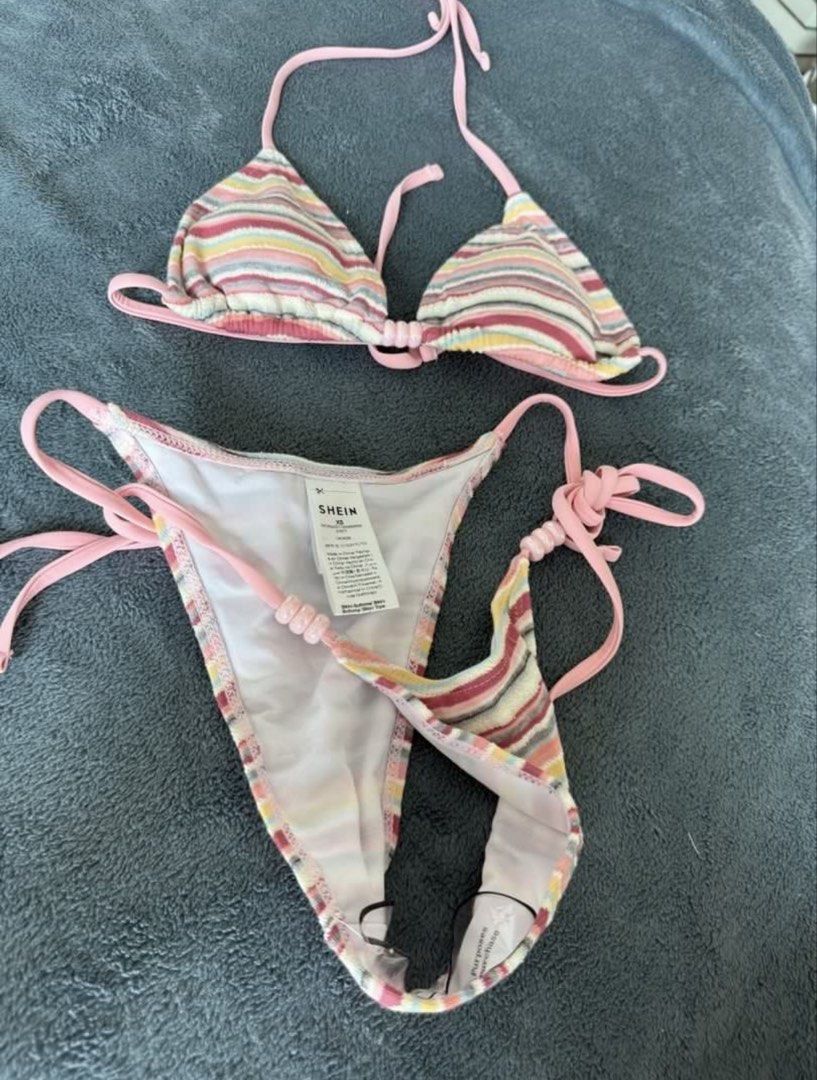 SHEIN Striped Bikini Set (Category: Bikinis & Swimsuits) located in Quezon City. Submitted by japfoodl0ver (Listing ID 1466439880, Image 3). Description: - Brand: SHEIN - Size: XS (tag attached) - Set includes: Triangle top, side-tie bottoms, and matching shorts - Details: Multi-colored stripes, pink straps, and cute bead accents on strings - Condition: Used once - Bought from another carouseller, pics are from her - Price is firm.