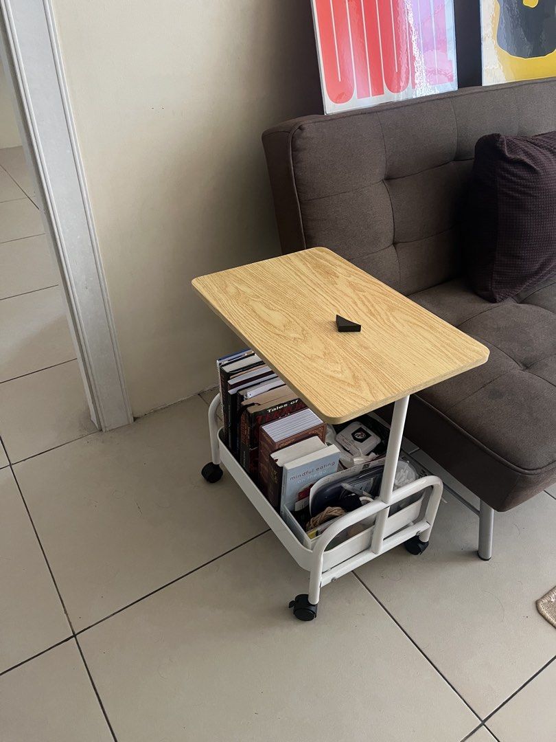 Side table (Category: Shelves, Cabinets & Racks) located in Manila. Submitted by kyleoliveros (Listing ID 1466359082, Image 3). Description: - Mobile bedside table with smooth-rolling wheels - Stylish wooden top paired with a sturdy white metal frame - Convenient lower storage basket for books and small items - Compact size, ideal for small spaces beside a bed or sofa - Previously used in a clean bedroom setting and well-maintained RFS: Planning 