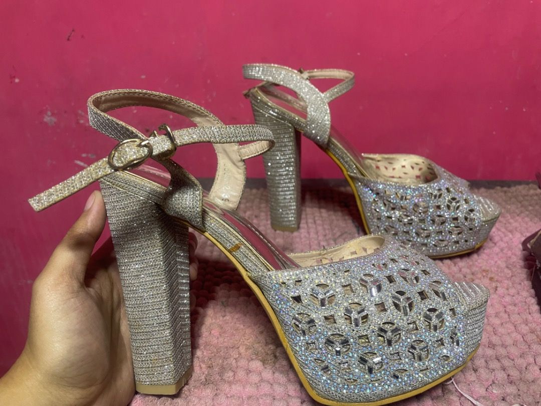 Silver High Heels Size 39 (Category: Heels) located in Bacoor. Submitted by prelovedbyparis (Listing ID 1466561820, Image 1). Description: - Style: Silver glitter platform heels with chunky block heels - Details: Cutout pattern on front strap and ankle strap with buckle closure - Size: 39 (stamped on sole) - Condition: Soles show minor dirt and scuffs from previous wear - Perfect for parties, events, and nights out Used once only for JS Prom Loc: