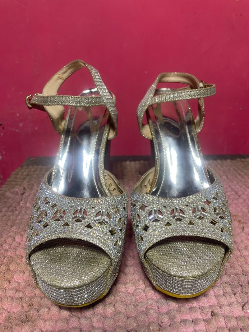 Silver High Heels Size 39 (Category: Heels) located in Bacoor. Submitted by prelovedbyparis (Listing ID 1466561820, Image 3). Description: - Style: Silver glitter platform heels with chunky block heels - Details: Cutout pattern on front strap and ankle strap with buckle closure - Size: 39 (stamped on sole) - Condition: Soles show minor dirt and scuffs from previous wear - Perfect for parties, events, and nights out Used once only for JS Prom Loc: