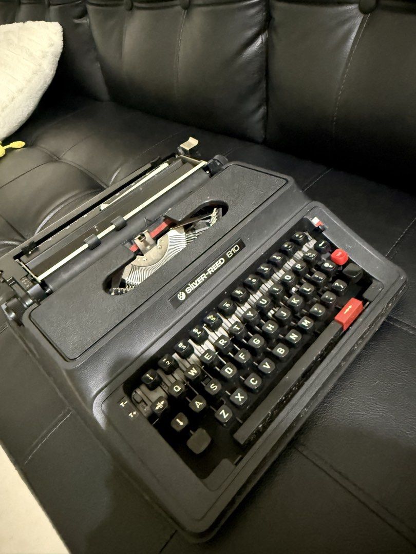 Silver-Reed 810 Portable Typewriter (Category: Office & Business Technology) located in Taguig. Submitted by baghabitmnl (Listing ID 1466477336, Image 2). Description: - Brand/Model: Silver-Reed 810 Manual Typewriter - Color: Classic black with white lettering - Keyboard: Standard QWERTY layout - Condition: Fully functional, well-maintained mechanical parts - Inclusions: Matching black hard protective case with carrying handle - Perfect for: Crea