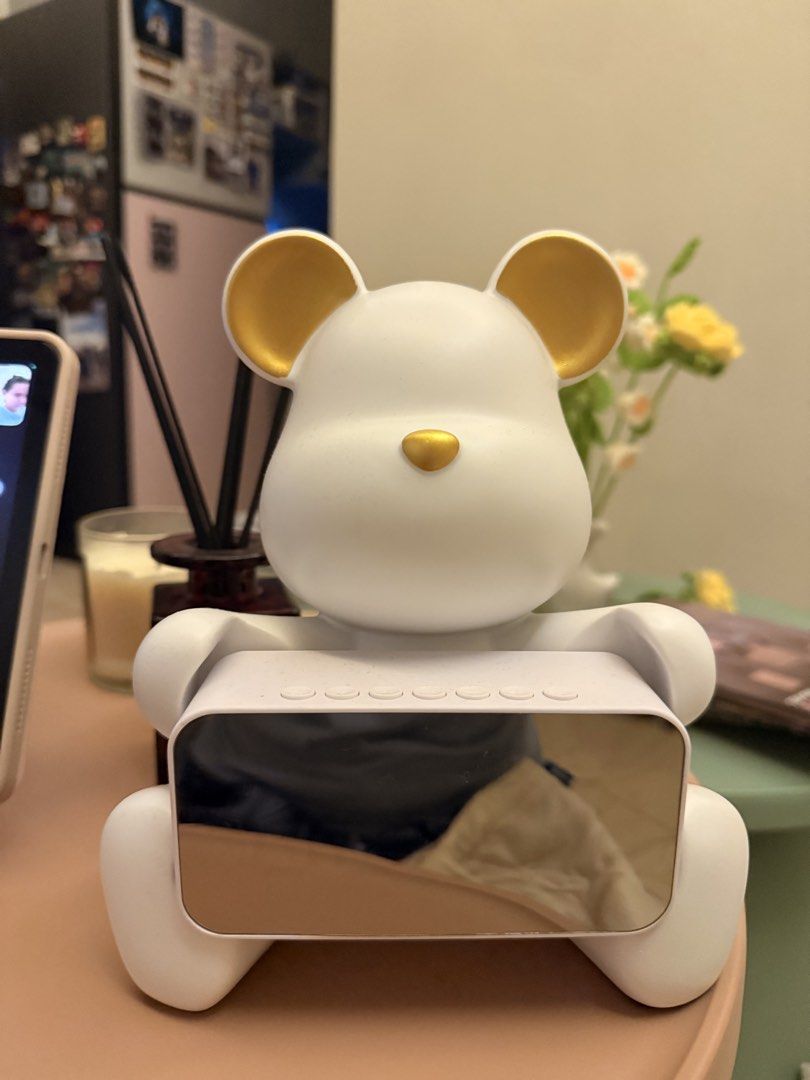 Sitting bear clock (Category: Clocks) located in Mandaluyong City. Submitted by riz_040521 (Listing ID 1466467747, Image 1). Description: • 2-in-1 Design: The digital clock unit can be detached or placed back onto the bear stand, allowing it to double as a stylish room decoration. • Smart Features: Aside from displaying a 24-hour clock, it includes built-in settings for an alarm clock and weather updates. • Audio & Connectivity: It comes equipped