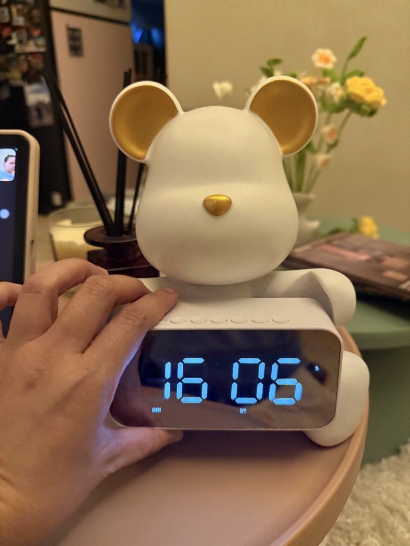 Sitting bear clock (Category: Clocks) located in Mandaluyong City. Submitted by riz_040521 (Listing ID 1466467747, Image 3). Description: • 2-in-1 Design: The digital clock unit can be detached or placed back onto the bear stand, allowing it to double as a stylish room decoration. • Smart Features: Aside from displaying a 24-hour clock, it includes built-in settings for an alarm clock and weather updates. • Audio & Connectivity: It comes equipped
