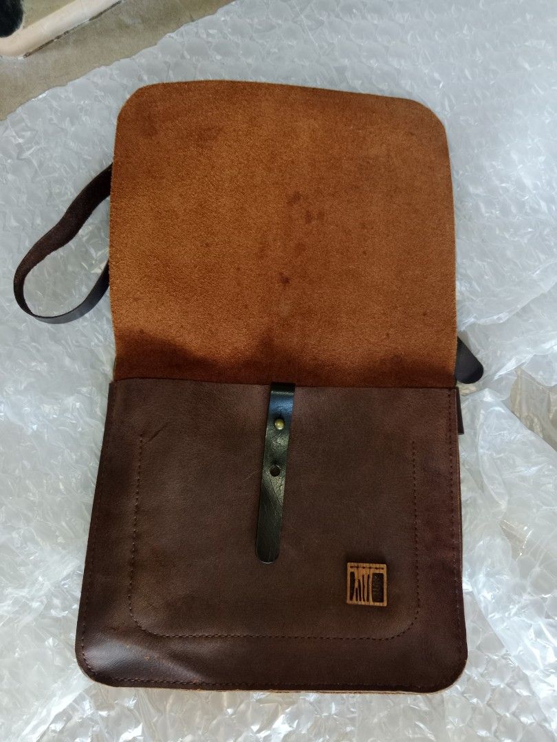 Sling bag - Bags by Rubbertree Leather - secondhand (Category: Luxury Bags & Wallets) located in Bayambang. Submitted by lucky_faststar_74a229 (Listing ID 1459569434, Image 2). Description: Chocolate brown textured leather body paired with a durable, adjustable dark brown leather shoulder strap and premium brass hardware. Dimensions: 30cm (L) × 13cm (W) × 24cm (H) Condition: The structure is intact, and the leather has been well-maintained. Shows