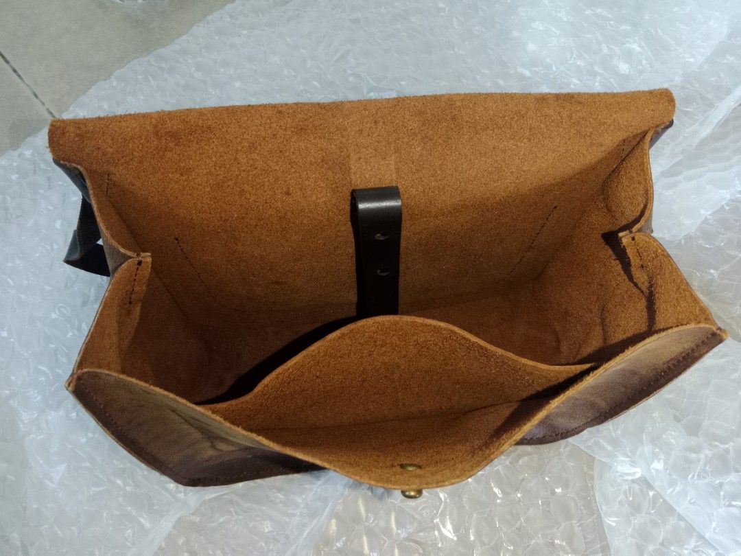 Sling bag - Bags by Rubbertree Leather - secondhand (Category: Luxury Bags & Wallets) located in Bayambang. Submitted by lucky_faststar_74a229 (Listing ID 1459569434, Image 3). Description: Chocolate brown textured leather body paired with a durable, adjustable dark brown leather shoulder strap and premium brass hardware. Dimensions: 30cm (L) × 13cm (W) × 24cm (H) Condition: The structure is intact, and the leather has been well-maintained. Shows