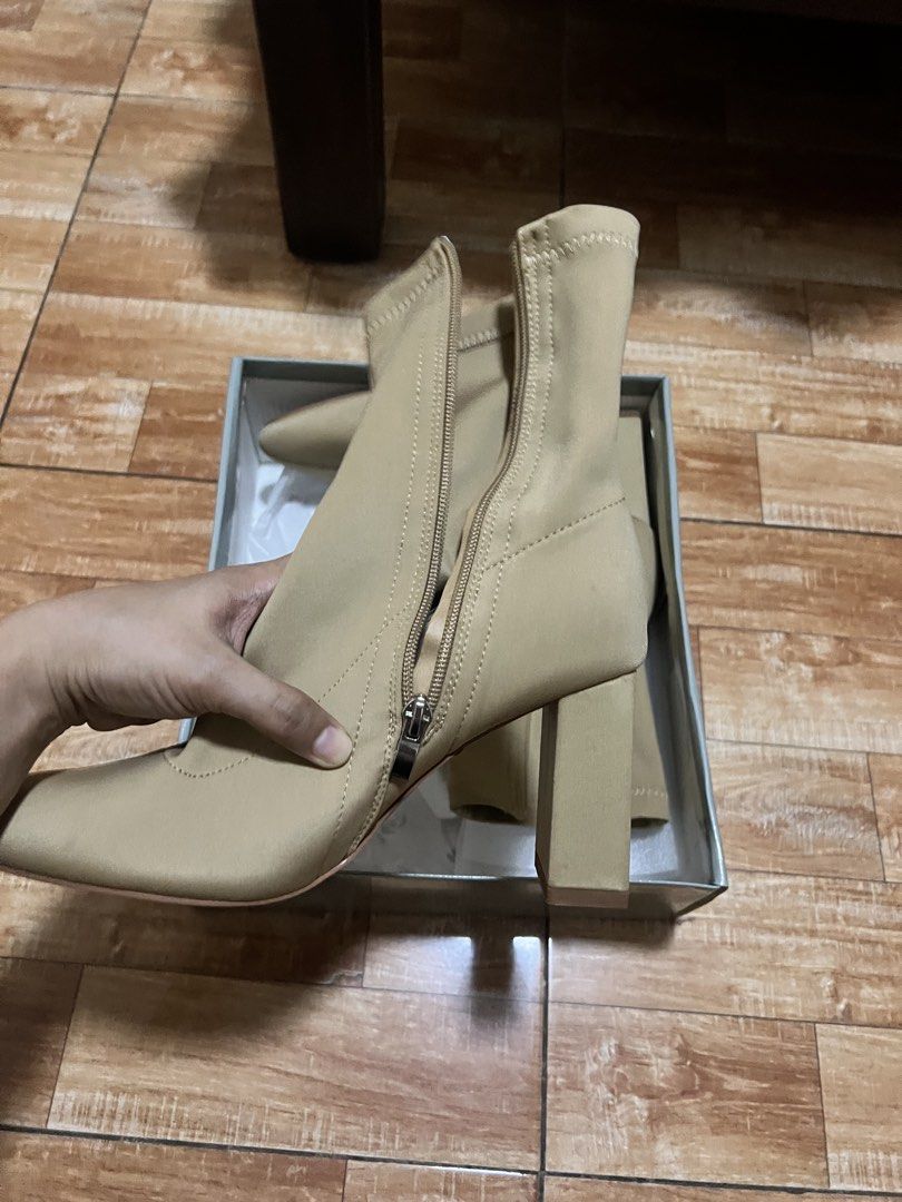 Gibi Beige Heeled Boots Size 39 (Category: Boots) located in Pasig City. Submitted by notyouraveragestuff (Listing ID 1466464257, Image 2). Description: - Brand: SM Store - Model: BT 7484 - Color: Dark beige (versatile neutral) - Size: 39 - Features: Stretch material, block heels, pointed toe, side zipper closure - Condition: Brand new, never worn out, clean soles - Inclusion: Original box with price tag attached Never worn orig price 1999.