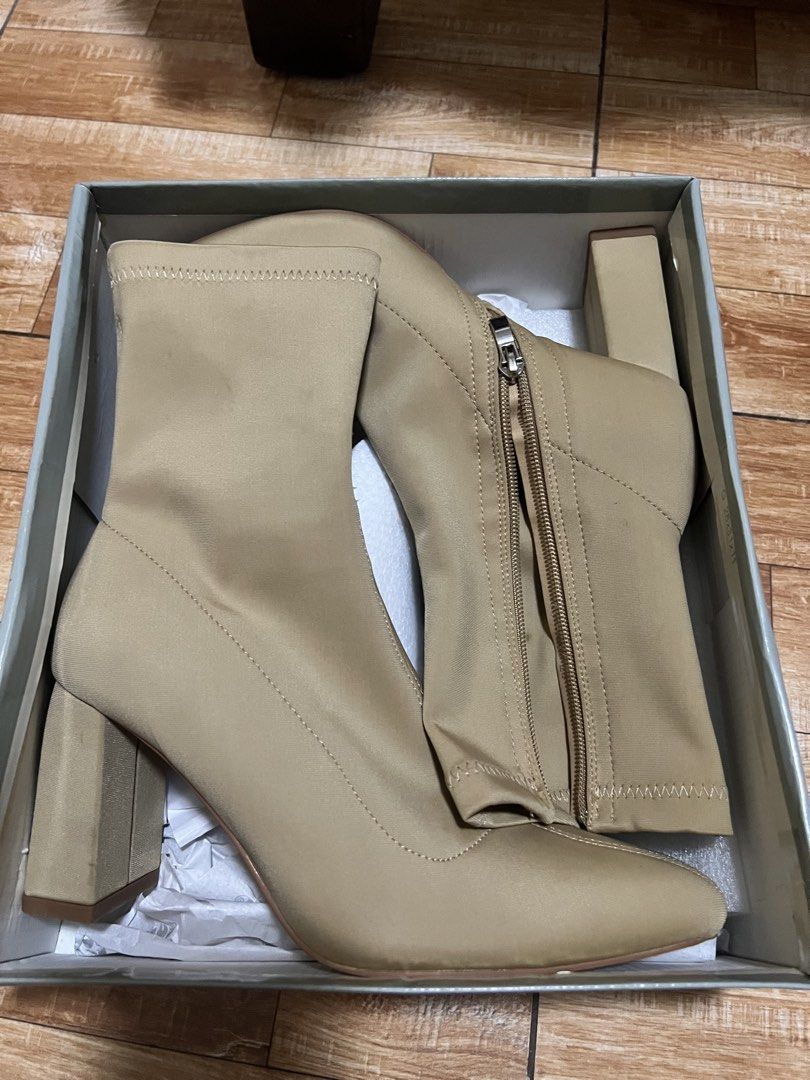Gibi Beige Heeled Boots Size 39 (Category: Boots) located in Pasig City. Submitted by notyouraveragestuff (Listing ID 1466464257, Image 1). Description: - Brand: SM Store - Model: BT 7484 - Color: Dark beige (versatile neutral) - Size: 39 - Features: Stretch material, block heels, pointed toe, side zipper closure - Condition: Brand new, never worn out, clean soles - Inclusion: Original box with price tag attached Never worn orig price 1999.