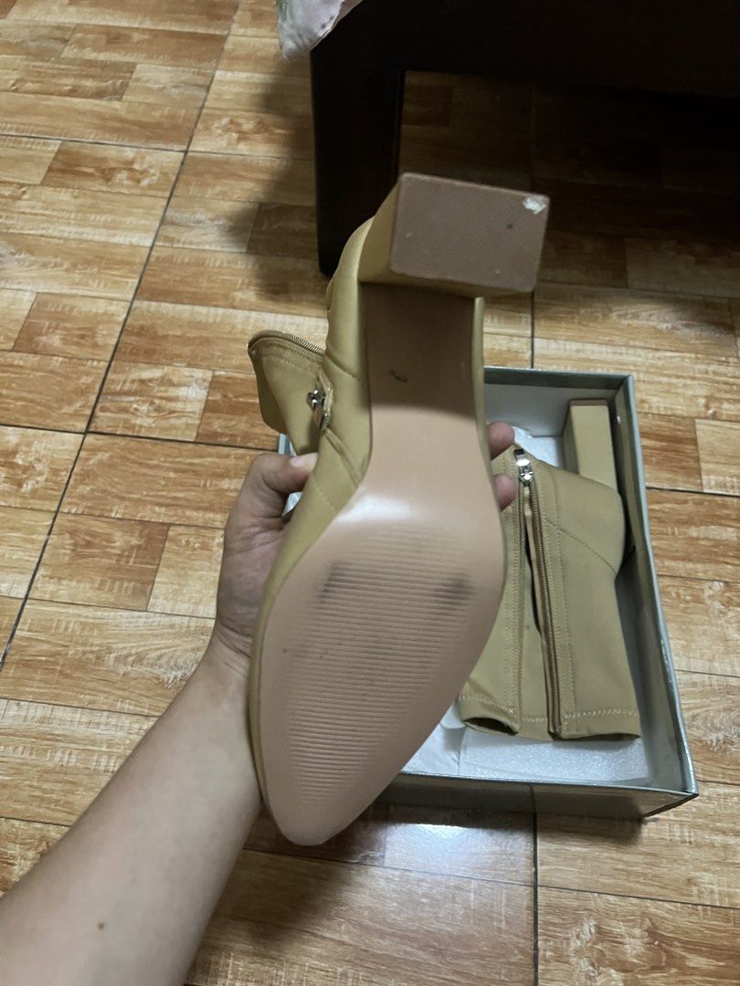 Gibi Beige Heeled Boots Size 39 (Category: Boots) located in Pasig City. Submitted by notyouraveragestuff (Listing ID 1466464257, Image 3). Description: - Brand: SM Store - Model: BT 7484 - Color: Dark beige (versatile neutral) - Size: 39 - Features: Stretch material, block heels, pointed toe, side zipper closure - Condition: Brand new, never worn out, clean soles - Inclusion: Original box with price tag attached Never worn orig price 1999.