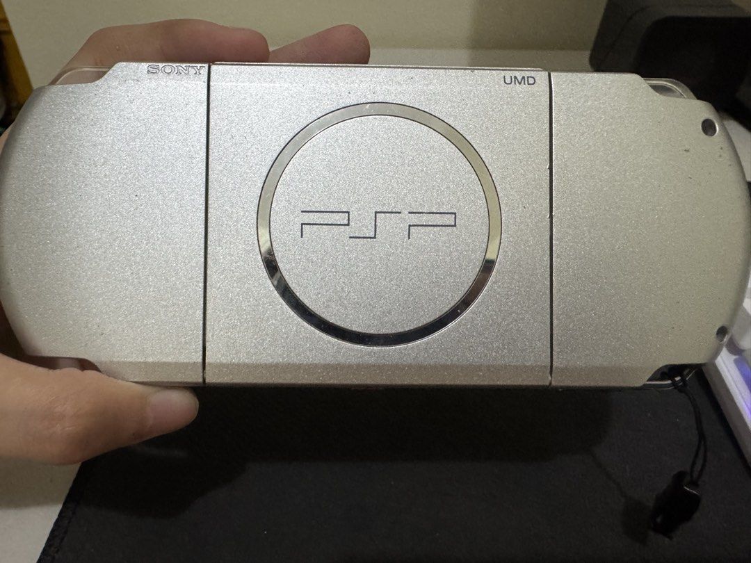 Sony PSP 3000 (Category: PlayStation) located in Binan City. Submitted by emwieee (Listing ID 1466525893, Image 2). Description: - issue: line sa LCD as u can see sa picture but di nakaka affect sa performance since the rest okay na okay naman at nag fufunction nang tama - w/ charger, games and case - sign of usage meron din normal sa second hand at sa isang 21 yrs old na handheld console biñan laguna area.