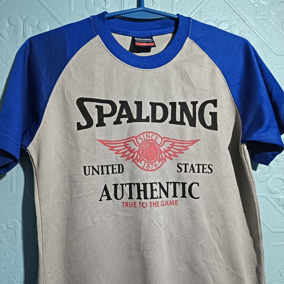 SPALDING AUTHENTIC ACTIVE WEAR (Category: Activewear) located in Quezon City. Submitted by zoesmithshop (Listing ID 1466478498, Image 3). Description: SPALDING authentic T-shirt Size- Small No issue good condition Color -Blue & grey This retro Spalding raglan tee features bold royal blue sleeves and a classic winged 1876 basketball graphic.