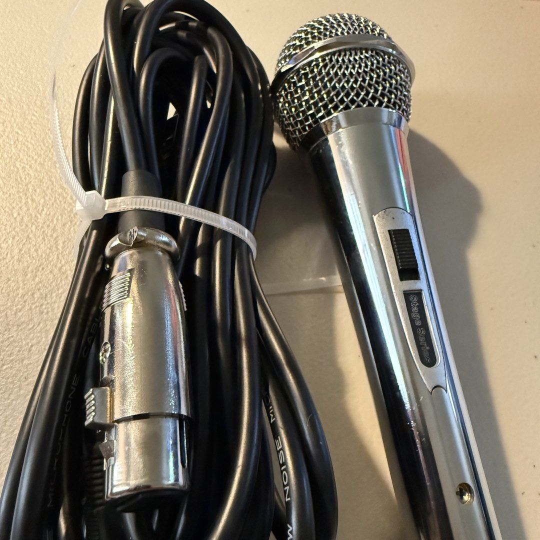 Stage Series Dynamic Microphone with Long Cable (Category: Microphones) located in Manila. Submitted by cheemkenn (Listing ID 1466414689, Image 3). Description: - good for karaokes - RFS: I bought a new microphone that is good for streaming - Model: Silver Stage Series Handheld Microphone - Condition: Clean and shiny grille, well-maintained - Control: Built-in on/off switch on the metal handle - Includes: Long black microphone cable with XLR and 