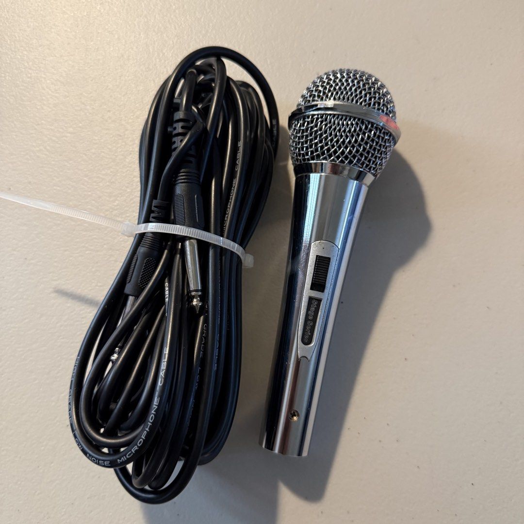 Stage Series Dynamic Microphone with Long Cable (Category: Microphones) located in Manila. Submitted by cheemkenn (Listing ID 1466414689, Image 2). Description: - good for karaokes - RFS: I bought a new microphone that is good for streaming - Model: Silver Stage Series Handheld Microphone - Condition: Clean and shiny grille, well-maintained - Control: Built-in on/off switch on the metal handle - Includes: Long black microphone cable with XLR and 