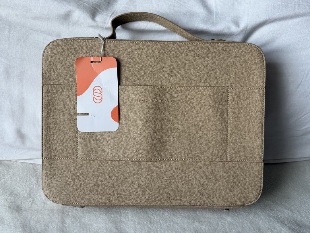 Straightforward Beige DVL Lusso Laptop Bag (Category: Laptop Bags & Sleeves) located in Manila. Submitted by jairahncle (Listing ID 1466395974, Image 2). Description: - Brand: Straightforward (Tag still attached) - Color: Elegant beige with silver hardware accents - Material/Texture: Saffiano-style finish - Closure: Full wrap-around zipper with top handle design - Interior: Includes a zippered pocket and open storage space for your laptop and ess