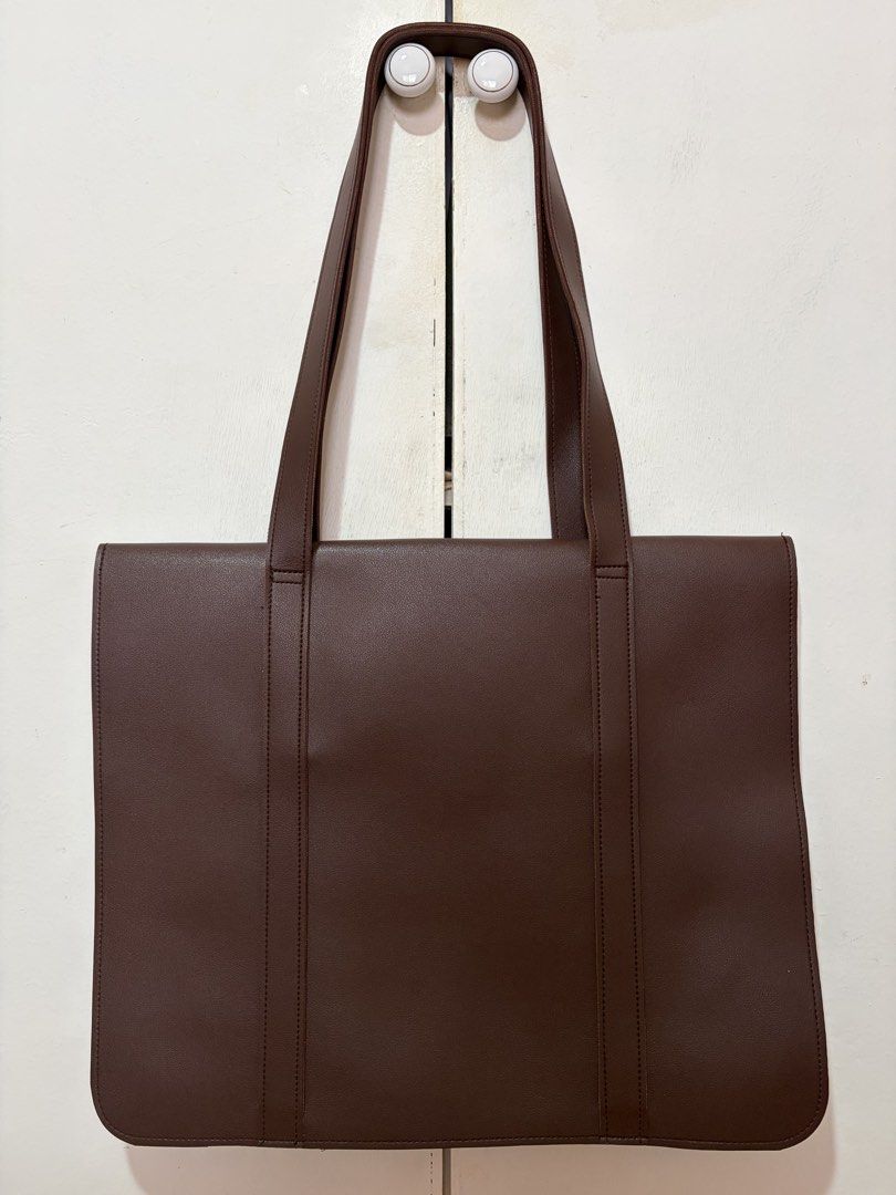 Straightforward Dark Brown Leather Tote Bag (Category: Tote Bags) located in Dasmarinas. Submitted by luvaide (Listing ID 1466390135, Image 2). Description: - Brand: Straightforward - Color: Deep chocolate dark brown - Material: High-quality leather - Design: Structured rectangular shape with clean stitching and minimalist aesthetic - Features: Dual shoulder straps and front flap closure with subtle embossed branding - Capacity: Fits documents, p