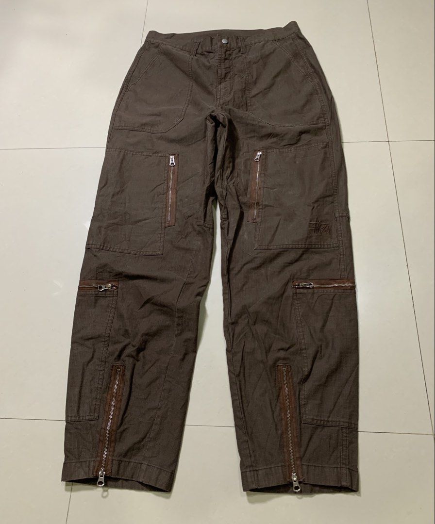 Stüssy Pigment Dyed Ripstop Flight Pants (Category: Chinos) located in Molave. Submitted by mysticbird_38213e (Listing ID 1466501388, Image 2). Description: Good condition Rare piece Ganda nito Working all zipper 8 POCKETS embroided logo Choco brown , good fade Angas nito boss DIMENSIONS : 30 on tag best fit 33 - 34 43 length 9.5 hem.