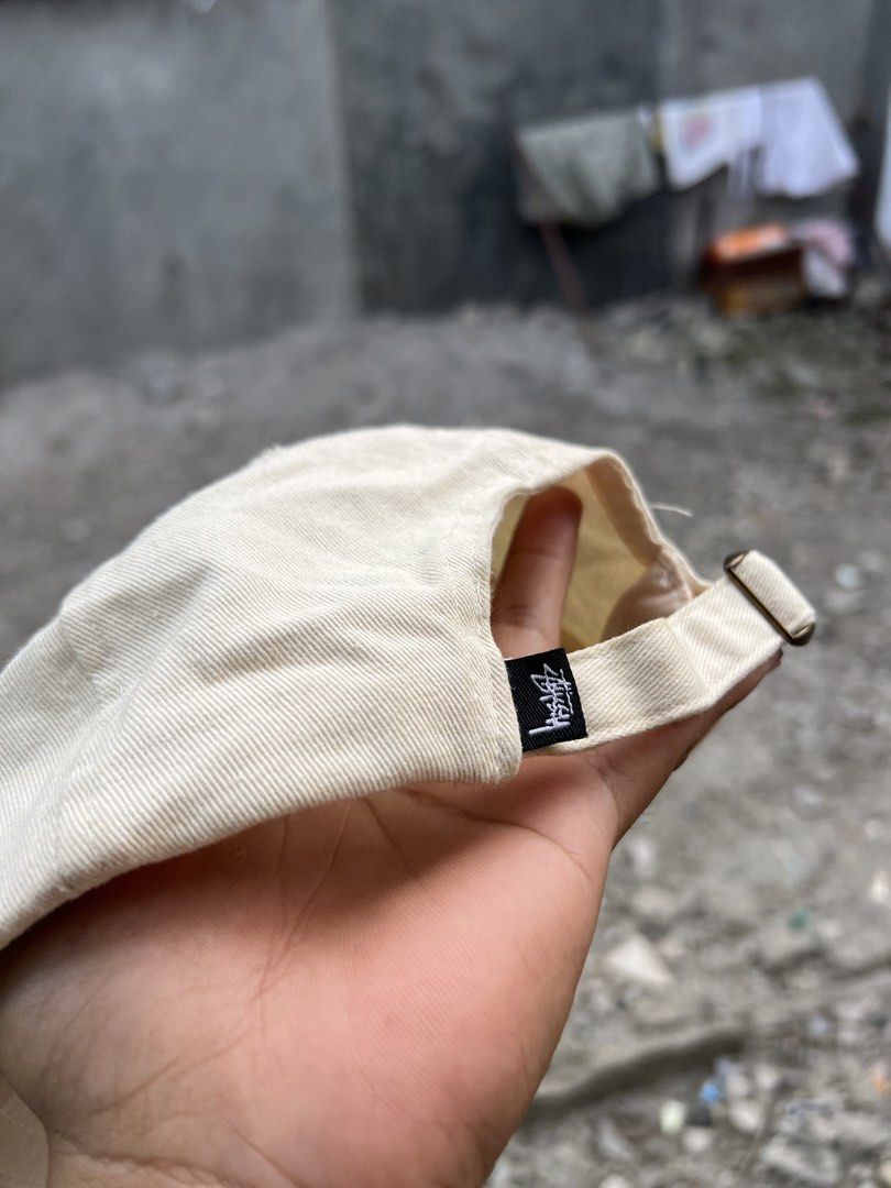 Stussy Cream Baseball Cap (Category: Caps & Hats) located in Iba. Submitted by saploot (Listing ID 1466479014, Image 2). Description: - Brand: Stussy - Style: Classic unstructured dad hat / strapback - Color: Cream (Neutral, easy to match) - Details: Signature front logo embroidery, small woven tag on back - Material: 100% Cotton - Closure: Adjustable metal strapback - Condition: Clean shape with minimal wear - Origin: Made in China.