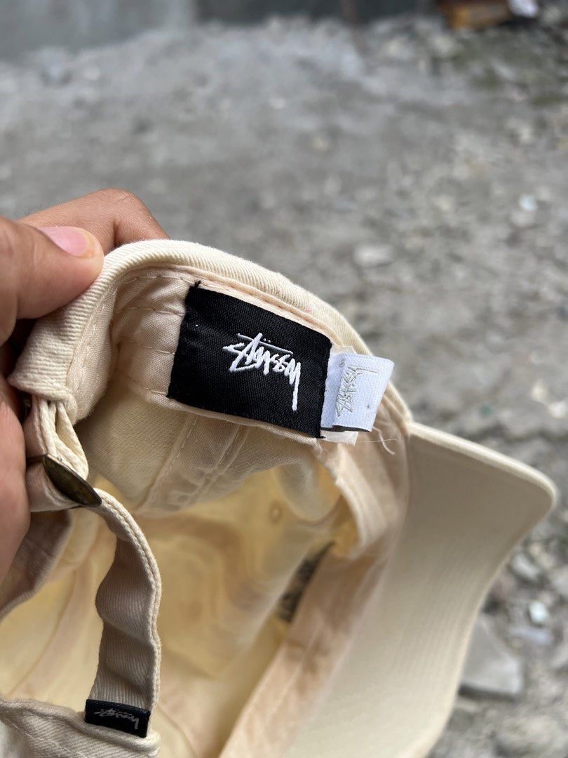 Stussy Cream Baseball Cap (Category: Caps & Hats) located in Iba. Submitted by saploot (Listing ID 1466479014, Image 3). Description: - Brand: Stussy - Style: Classic unstructured dad hat / strapback - Color: Cream (Neutral, easy to match) - Details: Signature front logo embroidery, small woven tag on back - Material: 100% Cotton - Closure: Adjustable metal strapback - Condition: Clean shape with minimal wear - Origin: Made in China.