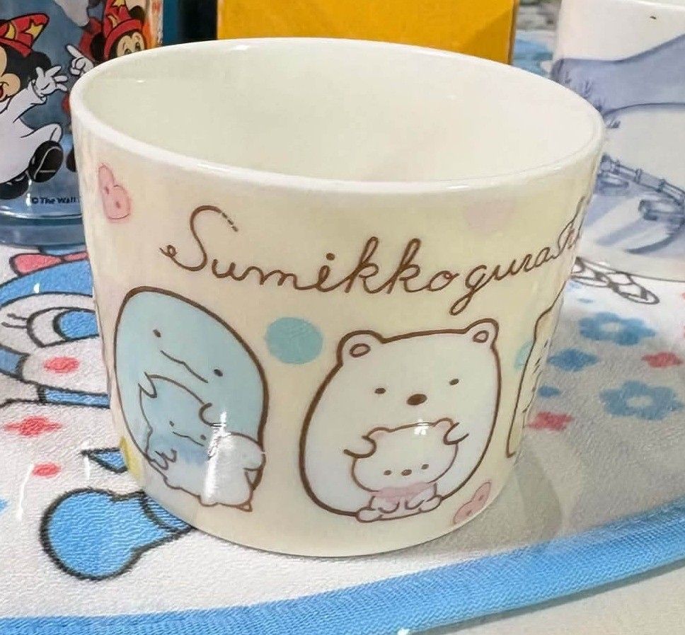 Sumikkogurashi Ceramic Mug Cup San-X (Category: Coffee & Tea Tableware) located in Quezon City. Submitted by peachhalves (Listing ID 1466417886, Image 1). Description: #sumikkogurashimug• #sumikkogurashi • #sanx • #sumikko - Authentic San-X Sumikkogurashi ceramic mug - Features popular characters Tokage and Shirokuma printed around the side - Cream-coloured with stylish script branding at the top front - Handleless, bowl-like design for a cozy gr