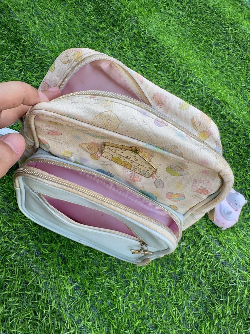 Sumikkogurashi Crossbody Bag Pastel Characters (Category: Cross-body Bags) located in Manila. Submitted by ronoarabbit.ph (Listing ID 1466438434, Image 2). Description: ❗️‼️Bag has signs of usage and flaws (see all photos) that’s why so cheap price. But still usable and for collector’s purposes.❗️‼️ - Authentic Sumikkogurashi crossbody bag with all-over pastel character prints - Light blue front pocket equipped with a cute star zipper pull - Adju
