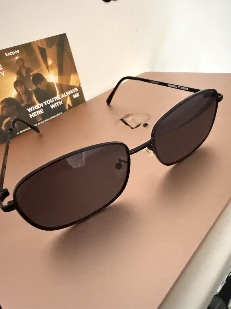 Sunnies Studios Black Sunglasses (Category: Sunglasses & Eyewear) located in Manila. Submitted by malcolm_169 (Listing ID 1466380710, Image 2). Description: - Brand: Sunnies Studios - Style: Rectangular frames with thin metal arms - Lenses: Dark tinted - Features: Includes nose pads - Condition: Clean and ready to wear.