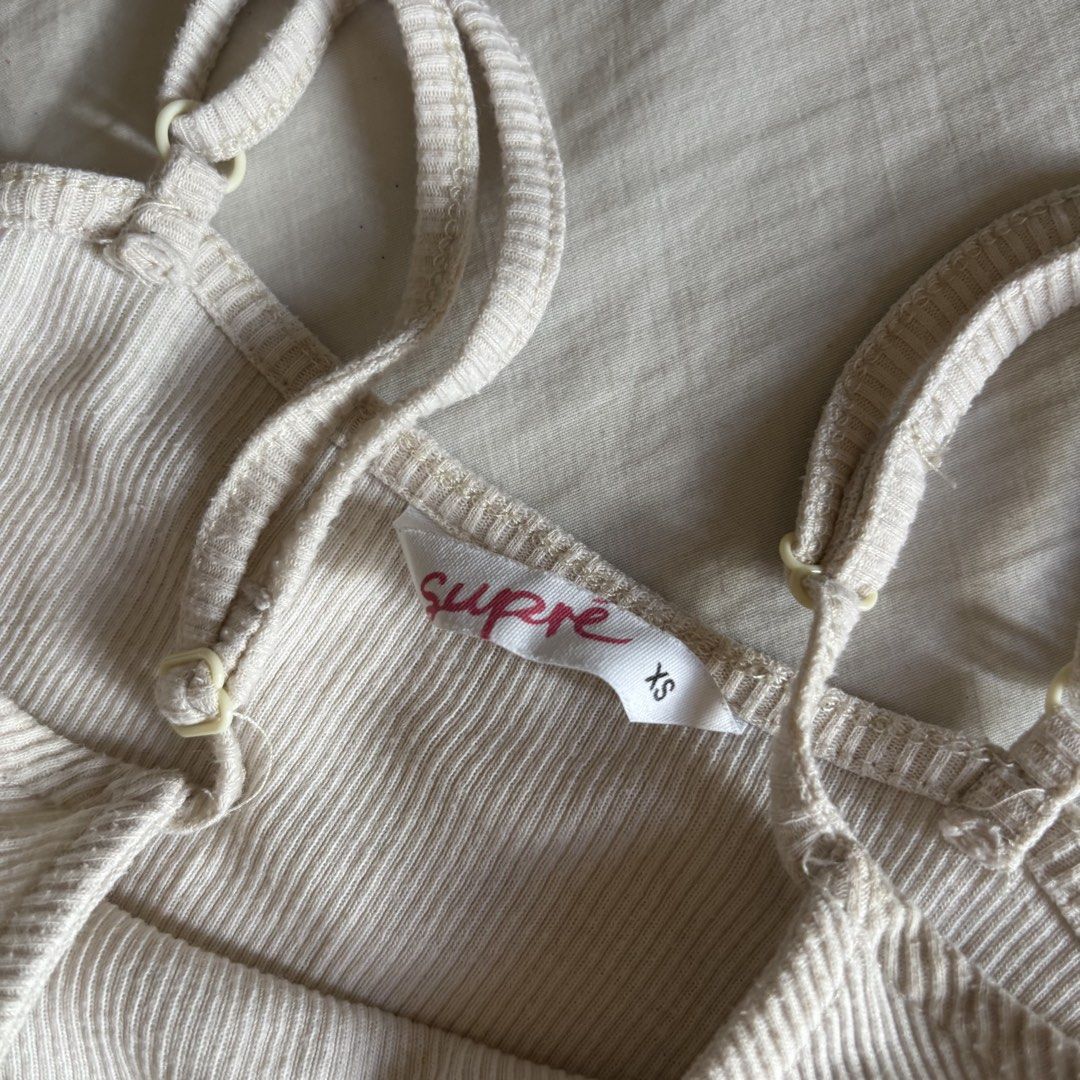 Supre Cream Ribbed Bodysuit Top (Category: Sleeveless) located in Binan City. Submitted by myprelovedhaul (Listing ID 1466397547, Image 3). Description: - fits xs to small! - no when worn photos! - last price posted! - please message only if sure buyer! - limited replies only. - Available unless mark as sold. - Ship via j&t or lalamove for same day. -Mode of payment: Gcash 📍Biñan Laguna .