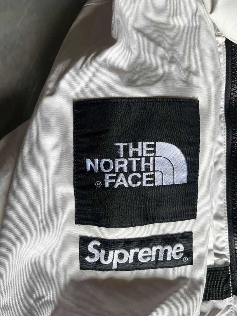 Supreme x The North Face Steep Tech Apogee Jacket (Category: Coats, Jackets and Outerwear) located in Quezon. Submitted by archivesss_666 (Listing ID 1466451313, Image 3). Description: Supreme x The North Face Steep Tech Apogee Jacket in white. Classic collaboration piece loaded with zip pockets and heavy branding on the arm, sleeve, and hood. Size large tag inside the red neck label. Bold rubber Steep Tech patch on the front chest pocket. Full z