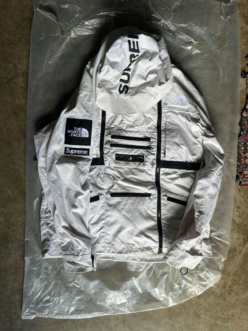 Supreme x The North Face Steep Tech Apogee Jacket (Category: Coats, Jackets and Outerwear) located in Quezon. Submitted by archivesss_666 (Listing ID 1466451313, Image 1). Description: Supreme x The North Face Steep Tech Apogee Jacket in white. Classic collaboration piece loaded with zip pockets and heavy branding on the arm, sleeve, and hood. Size large tag inside the red neck label. Bold rubber Steep Tech patch on the front chest pocket. Full z