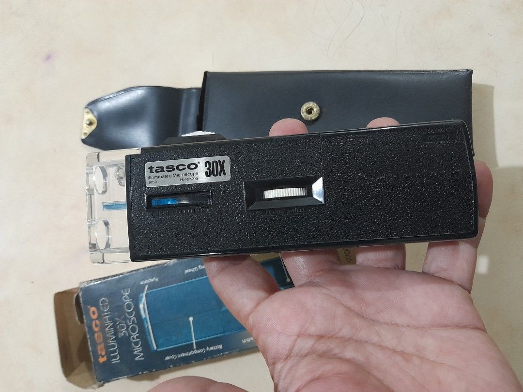 Tasco 30X Illuminated Pocket Microscope (Category: Stationery & School Supplies) located in Bocaue. Submitted by marajapansurplus (Listing ID 1466483580, Image 1). Description: - Brand: Tasco - Power: 30X magnification with built-in light source and focus adjustment - Condition: Vintage, pocket-sized science tool made in Hong Kong - Perfect for: Coin inspection, hobbies, and field work - Inclusions: Original faux leather carrying pouch, manual, a