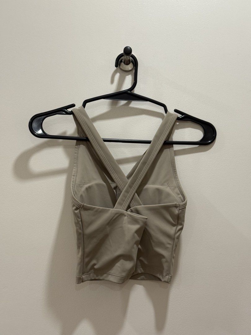 Taupe Active Crop Top with Button Detail (Category: Sleeveless) located in Caloocan City. Submitted by shop.andrea (Listing ID 1466448321, Image 2). Description: - Color: Taupe - Style: Activewear crop top with V-neckline and functional front buttons - Back Detail: Stylish criss-cross straps - Comfort: Built-in bra padding with soft, stretchy fabric - Versatility: Ideal for workouts or casual daily wear - Home: Clean, odor-free, and smoke-free en
