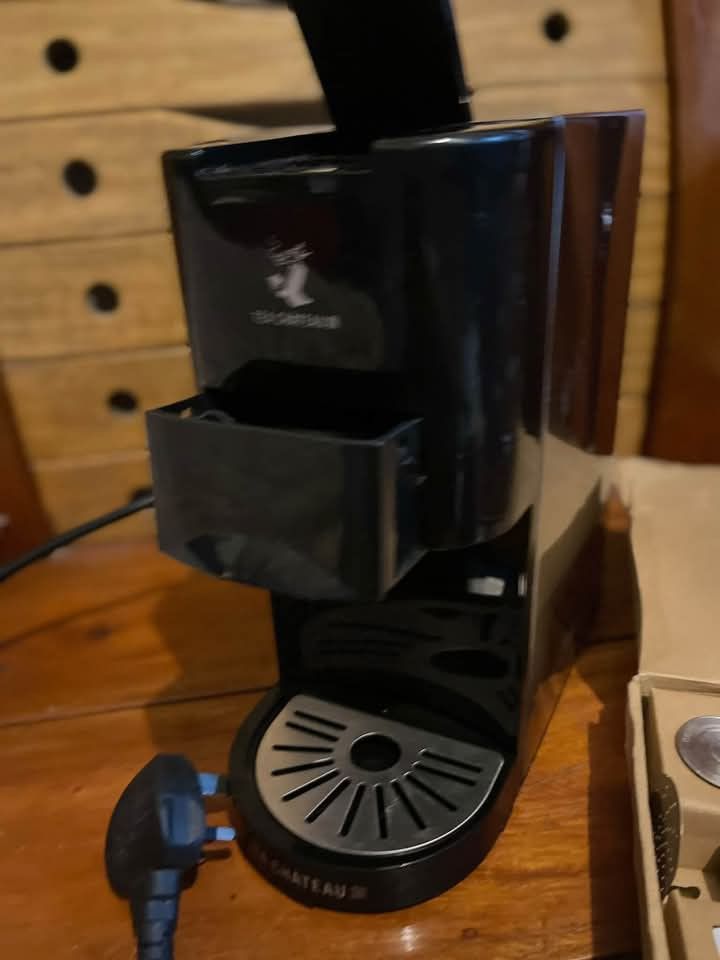 Tea Chateau Coffee Machine with Accessories Box (Category: Coffee Machines & Makers) located in Baguio. Submitted by ljen2574460 (Listing ID 1466336804, Image 3). Description: - Model: Tea Chateau Capsule Machine (Black & Silver) - Controls: 3 top buttons for different cup sizes - Condition: Clean drip tray and capsule compartment, powers on with standard plug - Includes: Original box, extra metal filter discs, cleaning brush, measuring spoon, an