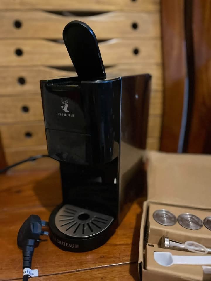 Tea Chateau Coffee Machine with Accessories Box (Category: Coffee Machines & Makers) located in Baguio. Submitted by ljen2574460 (Listing ID 1466336804, Image 2). Description: - Model: Tea Chateau Capsule Machine (Black & Silver) - Controls: 3 top buttons for different cup sizes - Condition: Clean drip tray and capsule compartment, powers on with standard plug - Includes: Original box, extra metal filter discs, cleaning brush, measuring spoon, an
