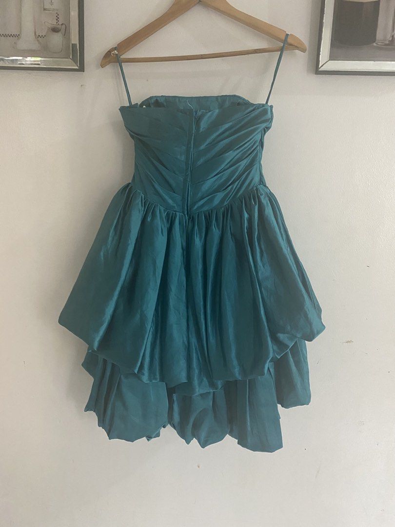 Teal Ruffle Cocktail Dress With Bow (Category: Dresses) located in Manila. Submitted by jossarisar23239 (Listing ID 1466400478, Image 2). Description: - Color: Teal green - Design: Strapless sweetheart neckline with optional spaghetti straps - Bodice: Flattering ruched design with a large front-center bow accent - Skirt: Voluminous layered bubble skirt with dramatic tiered ruffles - Closure: Secure back zip closure - Condition: Excellent, ready t
