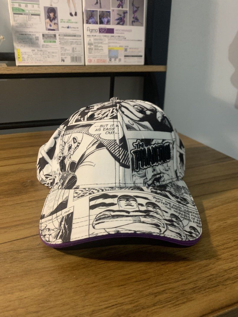 The Phantom Comic Book Print Baseball Cap (Category: Caps & Hats) located in Manila. Submitted by sellingmy.stuff (Listing ID 1466337048, Image 3). Description: - Authentic 2016 King Features Syndicate The Phantom merchandise - Eye-catching black and white comic book panel print across the entire cap - Embroidered The Phantom logo on the front panel - Stylish purple underside on the brim - Vibrant colorful comic panel inner lining - Adjustable st