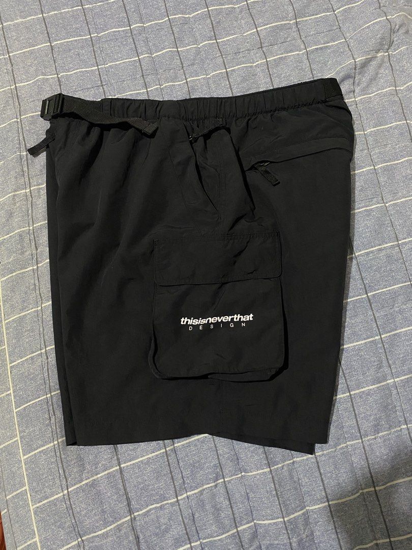 thisisneverthat Black Cargo Shorts with Belt (Category: Shorts) located in Escalante. Submitted by relicofthenorth.082630 (Listing ID 1466466526, Image 1). Description: - Brand: thisisneverthat - Color: Black - Style: Utility cargo shorts - Waist: Built-in adjustable belt with buckle closure - Pockets: Multiple pockets including side cargo pocket with white brand text print and back pocket with button snap - Details: Branded fabric label on back 