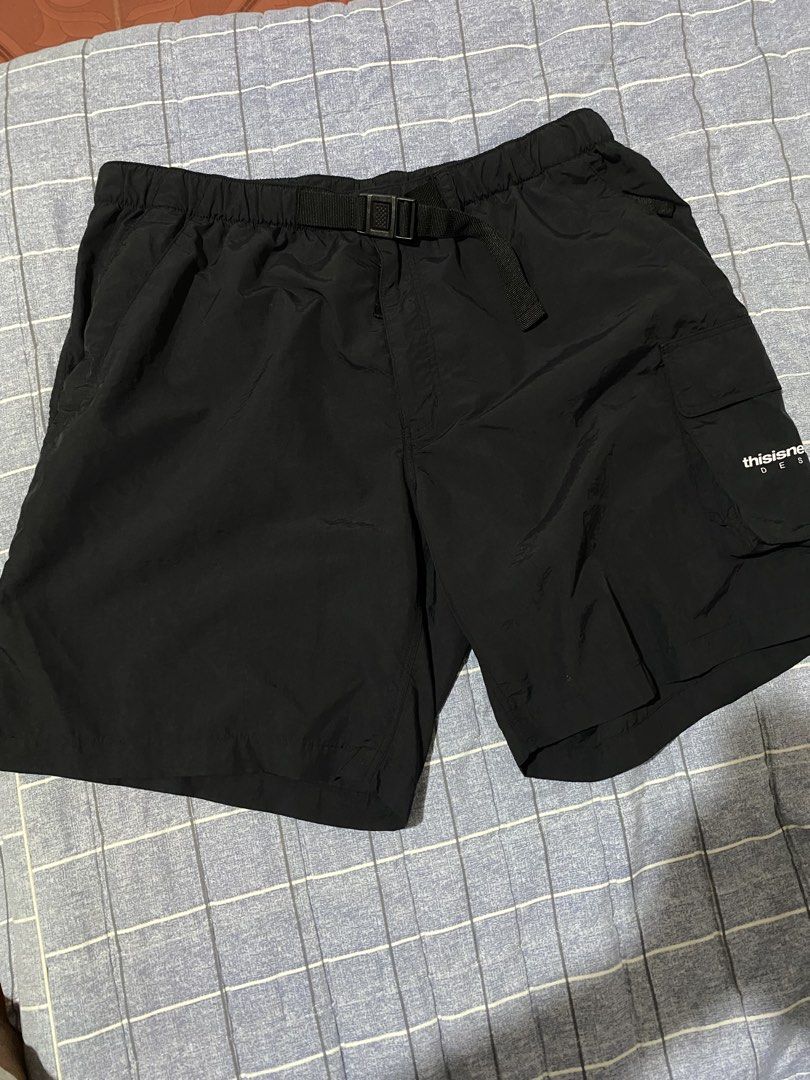 thisisneverthat Black Cargo Shorts with Belt (Category: Shorts) located in Escalante. Submitted by relicofthenorth.082630 (Listing ID 1466466526, Image 2). Description: - Brand: thisisneverthat - Color: Black - Style: Utility cargo shorts - Waist: Built-in adjustable belt with buckle closure - Pockets: Multiple pockets including side cargo pocket with white brand text print and back pocket with button snap - Details: Branded fabric label on back 