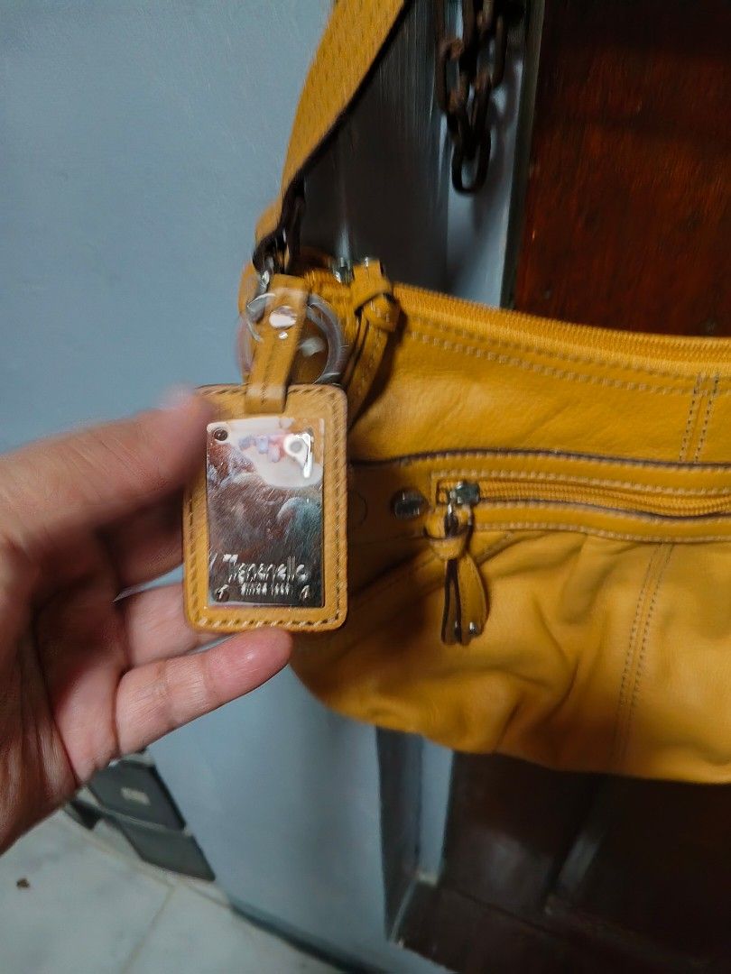 Tignanello Yellow Leather Shoulder Bag (Category: Shoulder Bags) located in Quezon City. Submitted by matcarla (Listing ID 1466517428, Image 2). Description: -Tignanello Bag From US - Color: Bright yellow - Material: Soft, high-quality leather - Exterior: Vertical front zip pocket, sturdy shoulder strap, metal logo plate - Interior: Patterned fabric lining with extra slip pockets for small items - Closure: Secure zip-top closure - Condition: Exce