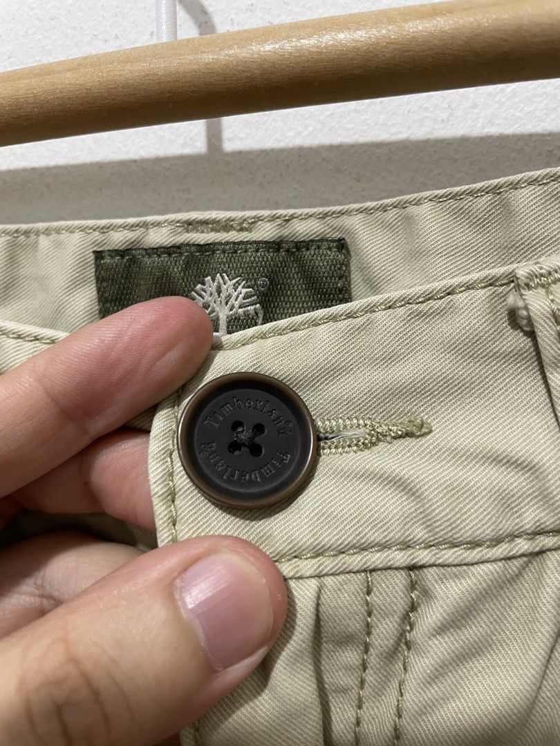 Timberland Khaki Chino Pants (Category: Chinos) located in Makati City. Submitted by nicolettel27186 (Listing ID 1466516702, Image 2). Description: - Brand: Timberland - Color: Classic khaki / neutral tan - Fit: Straight-leg cut - Details: Branded button closure and back leather patch with tree logo - Pockets: Two front pockets and two back welt pockets - Condition/Use: Great everyday casual trousers for work or weekend wear.