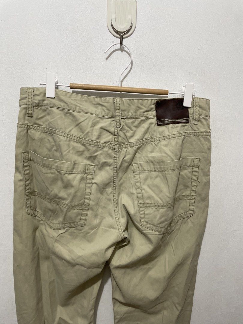 Timberland Khaki Chino Pants (Category: Chinos) located in Makati City. Submitted by nicolettel27186 (Listing ID 1466516702, Image 3). Description: - Brand: Timberland - Color: Classic khaki / neutral tan - Fit: Straight-leg cut - Details: Branded button closure and back leather patch with tree logo - Pockets: Two front pockets and two back welt pockets - Condition/Use: Great everyday casual trousers for work or weekend wear.